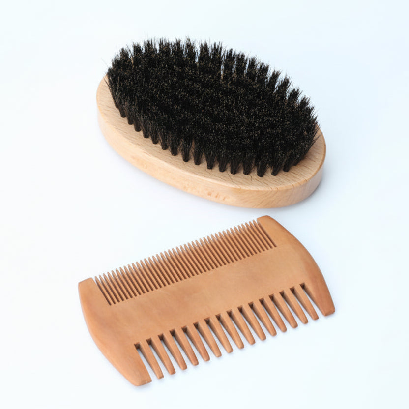 Wooden brush with black bristles and a wooden comb on a white background
